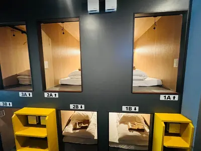 a room with three mirrors and two yellow tables at Otemachi Kamon Hotel in Tokyo