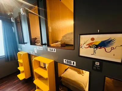 a room with two bunk beds and a painting on the wall at Otemachi Kamon Hotel in Tokyo