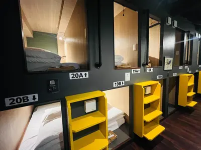 a room with some yellow bunk beds in it at Otemachi Kamon Hotel in Tokyo