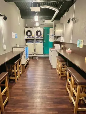 a large kitchen with wooden floors and white appliances at Otemachi Kamon Hotel in Tokyo