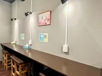 a bar in a room with lights on the wall at Otemachi Kamon Hotel in Tokyo
