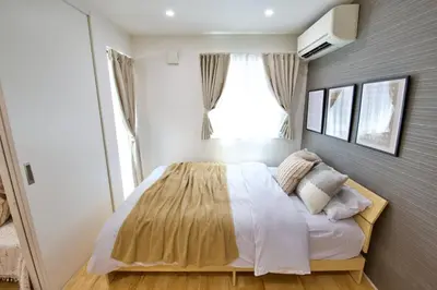 a bedroom with a large bed with a window at BH Terrace Hirai 103 in Tokyo