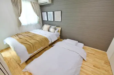 a bedroom with two beds and a window at BH Terrace Hirai 103 in Tokyo