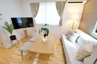 a living room with a couch and a table at BH Terrace Hirai 103 in Tokyo