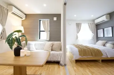 a bedroom with a bed and a couch at BH Terrace Hirai 103 in Tokyo