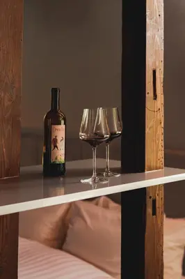 a bottle of wine and two glasses on a shelf at MU HEN KO Tokyo in Tokyo