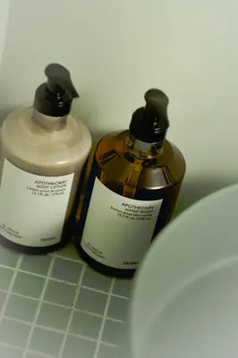 two bottles of soap sitting next to a toilet at MU HEN KO Tokyo in Tokyo