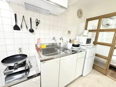 a small kitchen with a sink and a stove at Shinjuku Waseda C4 in Tokyo