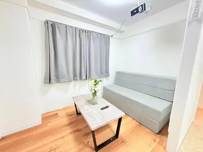 a living room with a couch and a table at Shinjuku Waseda C4 in Tokyo