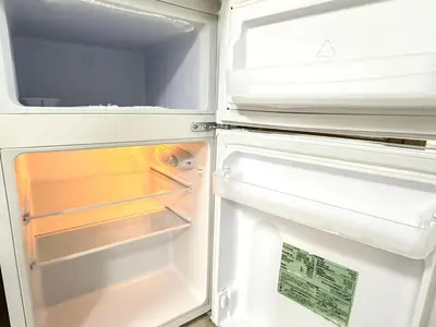an open refrigerator with its door open and its door at Shinjuku Waseda C4 in Tokyo