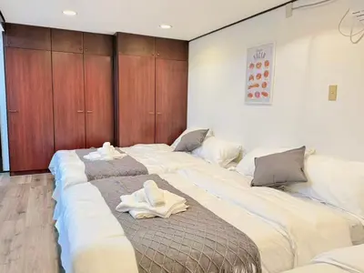 two large beds in a room with towels on them at Shinjuku Waseda Bravo 1 in Tokyo