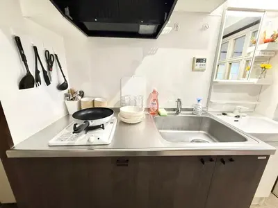 a kitchen counter with a sink and a stove at Shinjuku Waseda Bravo 1 in Tokyo