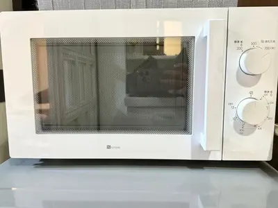a white microwave oven sitting on top of a counter at Shinjuku Waseda Bravo 1 in Tokyo