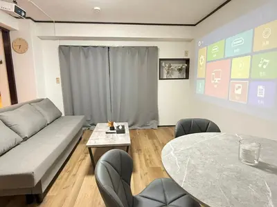 a living room with a couch and a table at Shinjuku Waseda Bravo 1 in Tokyo