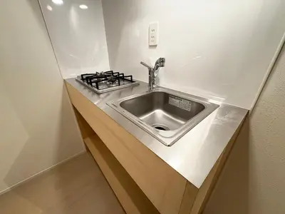 a kitchen counter with a sink and a stove at Alley House 201 in Tokyo