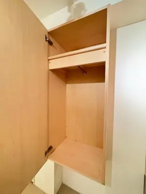 a small closet with wooden shelves in a room at Alley House 201 in Tokyo