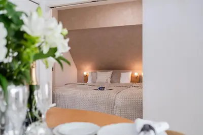 a bedroom with a bed and a table with flowers at Newly opened! Hidden Gem in Ikejiri - Quiet Stylish Minutes to Shibuya in Tokyo