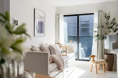 a white living room with a couch and a window at Newly opened! Hidden Gem in Ikejiri - Quiet Stylish Minutes to Shibuya in Tokyo