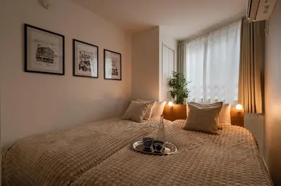a bedroom with a bed with a tray on it at Newly opened! Hidden Gem in Ikejiri - Quiet Stylish Minutes to Shibuya in Tokyo