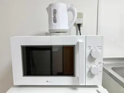 a white microwave with a jug on top of it at Shinjuku Waseda B3 in Tokyo