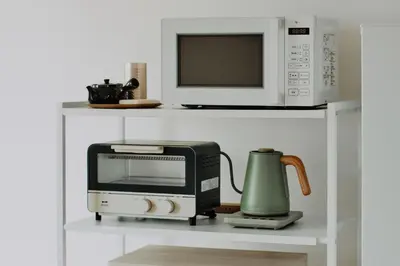 a microwave and a toaster oven on a shelf at Hazama in Tokyo