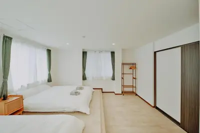 a bedroom with two beds and a ladder at Hazama in Tokyo