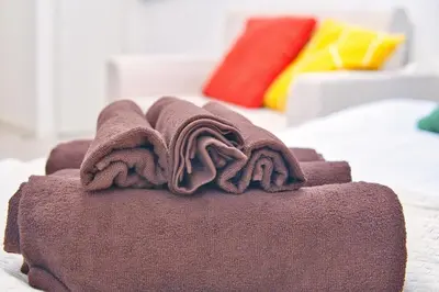 a pile of towels sitting on top of a bed at Mjk 201 8min Inaricho 11min Ueno Max 3 in Tokyo