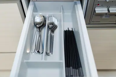 a drawer with silver utensils in a cabinet at Oasis IKEBUKURO in Tokyo