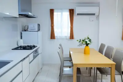 a kitchen and dining room with a table and chairs at Oasis IKEBUKURO in Tokyo