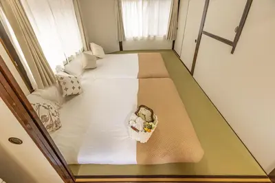 a room with two beds with a teddy bear in a basket at Cozy Japanese House in Sumida 2BR Direct to Narita in Tokyo