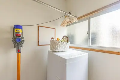 a small white refrigerator in a room with a lamp at Cozy Japanese House in Sumida 2BR Direct to Narita in Tokyo