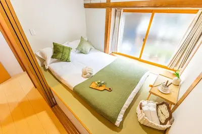 a small bed in a room with a window at Cozy Japanese House in Sumida 2BR Direct to Narita in Tokyo
