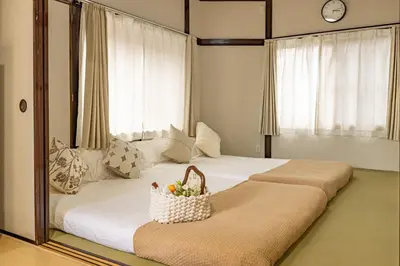 a bedroom with two beds and a basket of fruit at Cozy Japanese House in Sumida 2BR Direct to Narita in Tokyo