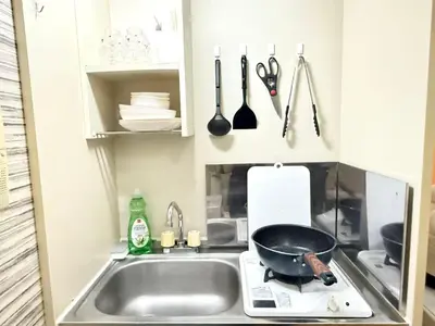 a kitchen with a sink and a frying pan and utensils at Shinjuku \u9ad8\u7530\u99ac\u5834\u30c6\u30e9\u30ce\u30d0B5 in Tokyo