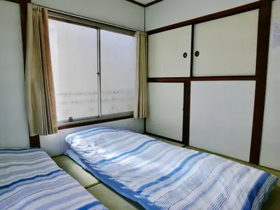 a small bedroom with a bed and a window at 4mins from sky tree Sumida area 3rooms Wifi in Tokyo