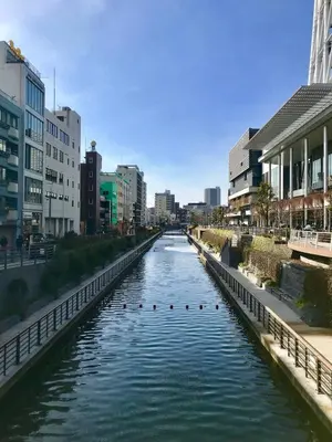 a river in the middle of a city with buildings at 4mins from sky tree Sumida area 3rooms Wifi in Tokyo
