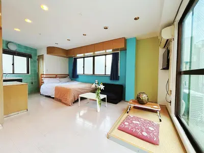 a bedroom with a bed and a tv in it at Asakusa Sakura-4F in Tokyo