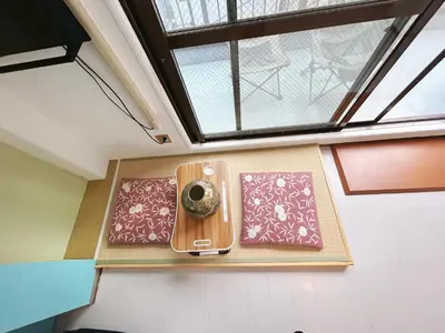 a room with a window and a table with aperature at Asakusa Sakura-4F in Tokyo