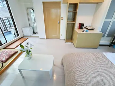a living room with a bed and a table at Asakusa Sakura-4F in Tokyo