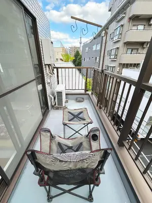 a balcony with a chair on top of a building at Asakusa Sakura-4F in Tokyo
