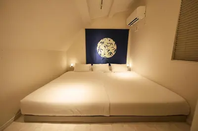 a bedroom with a white bed with lights on it at WANOYADO Tokyo - Shinjuku & Shibuya 8min - 3BR 81m2House - 10ppl - Family Friendly in Tokyo