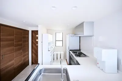 a white kitchen with a sink and a stove at WANOYADO Tokyo - Shinjuku & Shibuya 8min - 3BR 81m2House - 10ppl - Family Friendly in Tokyo