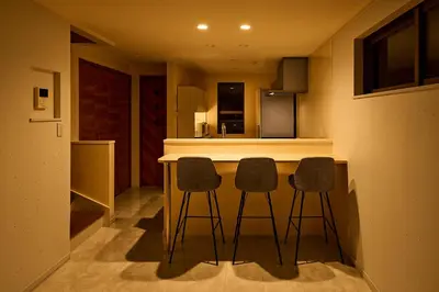 a kitchen with two bar stools and a counter at WANOYADO Tokyo - Shinjuku & Shibuya 8min - 3BR 81m2House - 10ppl - Family Friendly in Tokyo