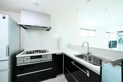a white kitchen with a sink and a stove at WANOYADO Tokyo - Shinjuku & Shibuya 8min - 3BR 81m2House - 10ppl - Family Friendly in Tokyo
