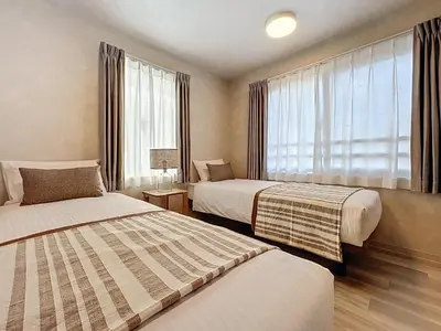 a hotel room with two beds and a window at Viento Ikebukuro in Tokyo