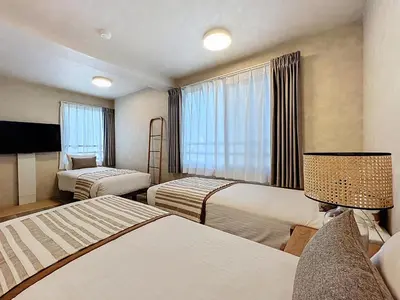 a hotel room with two beds and a window at Viento Ikebukuro in Tokyo
