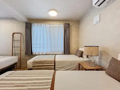 a hotel room with two beds and a window at Viento Ikebukuro in Tokyo