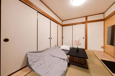 a bedroom with a bed and a table and a tv at SKY Building 301 - Skytree View Studio - Easy Airport Access in Tokyo