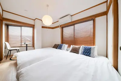 two beds in a room with two windows at SKY Building 301 - Skytree View Studio - Easy Airport Access in Tokyo