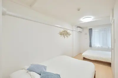 a bedroom with a bed and a chandelier at monthly akebonobashi in Tokyo